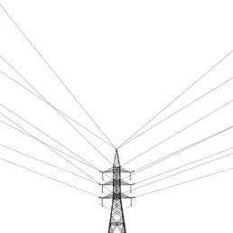 A power line tower stands centered against a white sky, with wires radiating symmetrically outward in all directions.