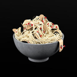 Concrete bowl filled with spaghetti entangled with multiple miniature skateboards, set against a black background.